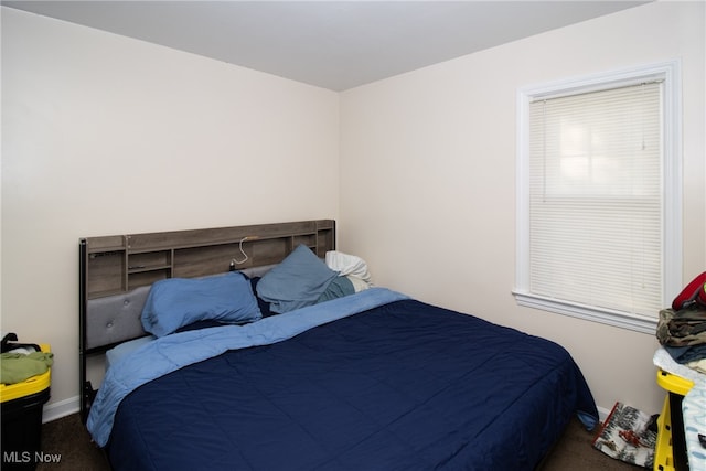 bedroom featuring dark carpet