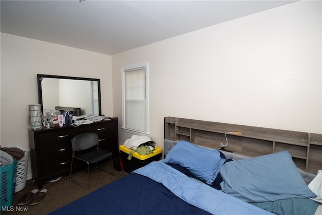 bedroom featuring dark colored carpet