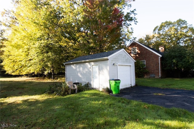 garage featuring a lawn