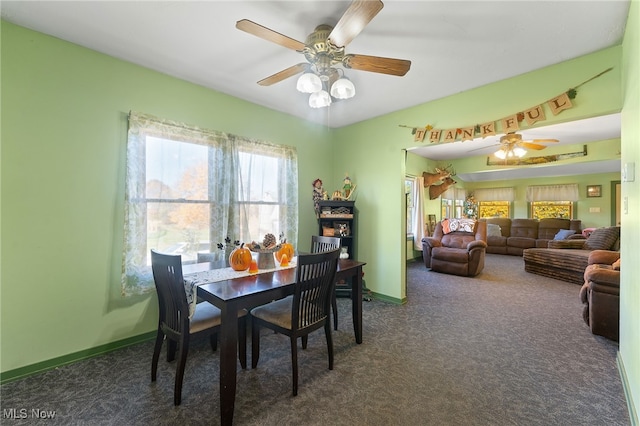 carpeted dining room with ceiling fan