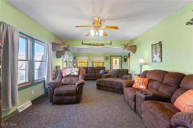 carpeted living room with ceiling fan