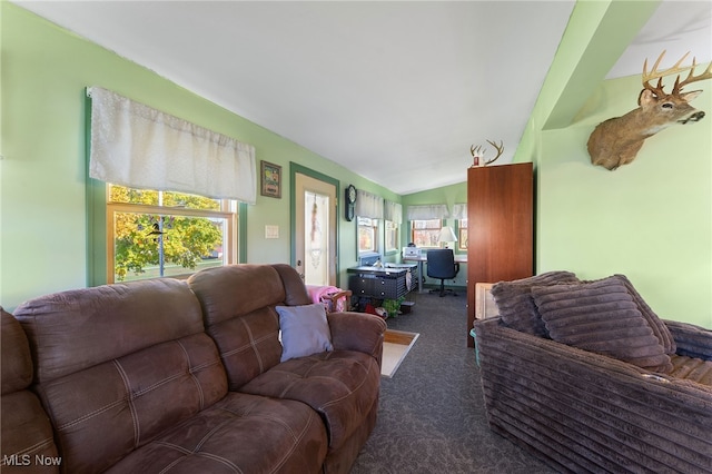 carpeted living room with lofted ceiling