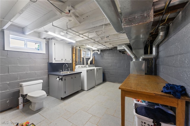 basement featuring washer and dryer and sink