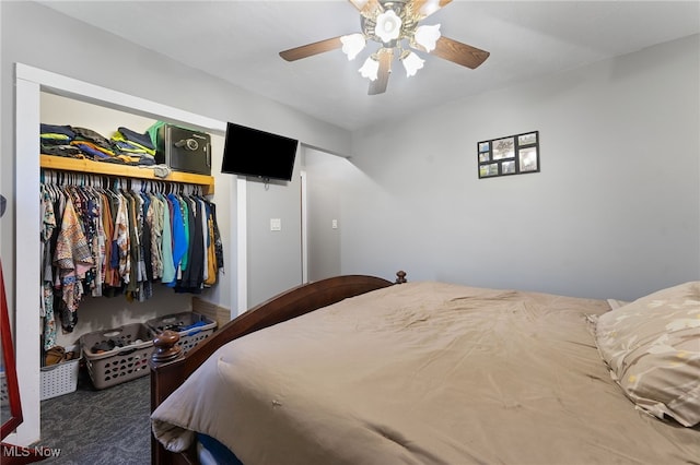 bedroom featuring dark colored carpet, a closet, and ceiling fan