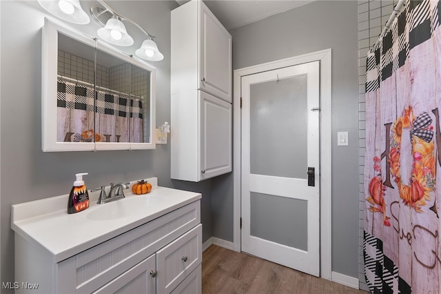 bathroom featuring vanity, a shower with shower curtain, and wood-type flooring