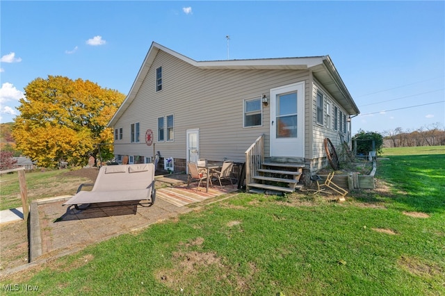 rear view of property with a lawn