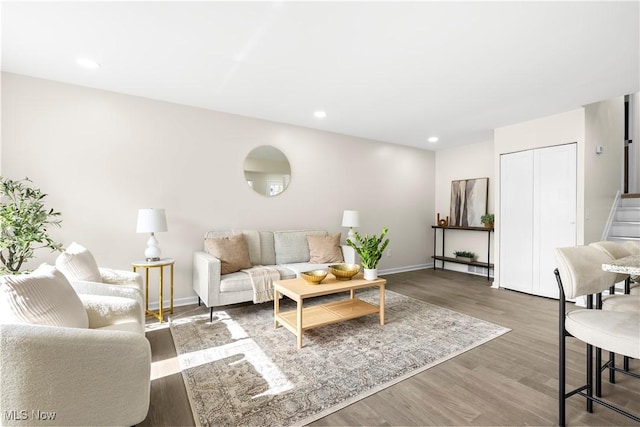 living area featuring stairway, recessed lighting, wood finished floors, and baseboards