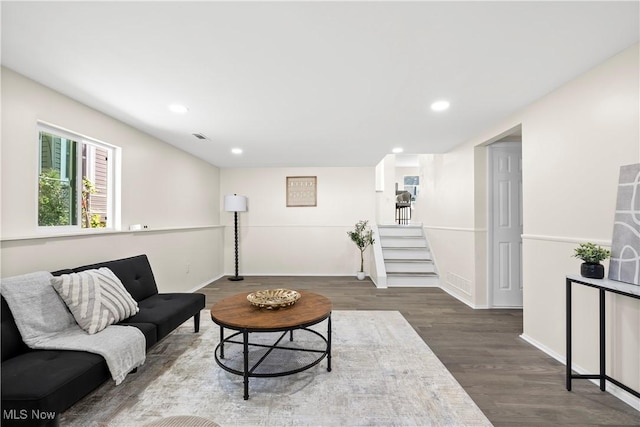 living area with stairway, wood finished floors, visible vents, baseboards, and recessed lighting