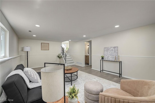 living room with recessed lighting, stairway, visible vents, and wood finished floors