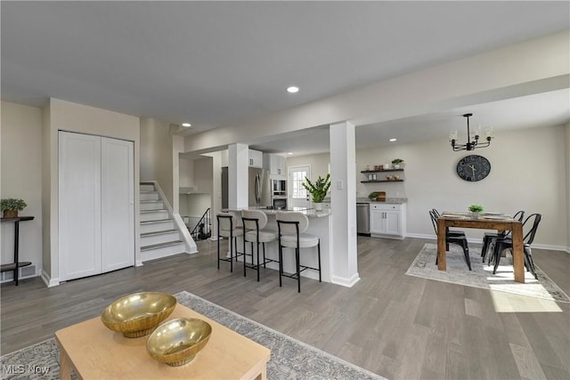 interior space featuring dark wood finished floors, white cabinets, appliances with stainless steel finishes, and baseboards