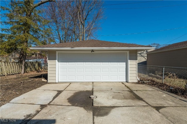 detached garage featuring fence