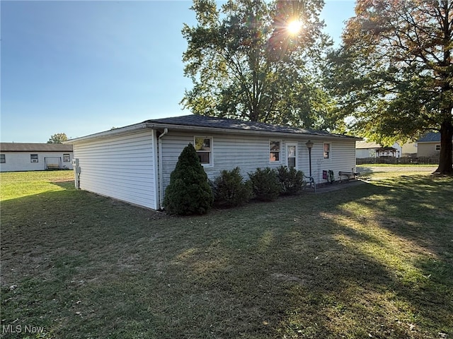 rear view of property featuring a lawn