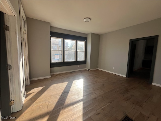 unfurnished bedroom with hardwood / wood-style flooring