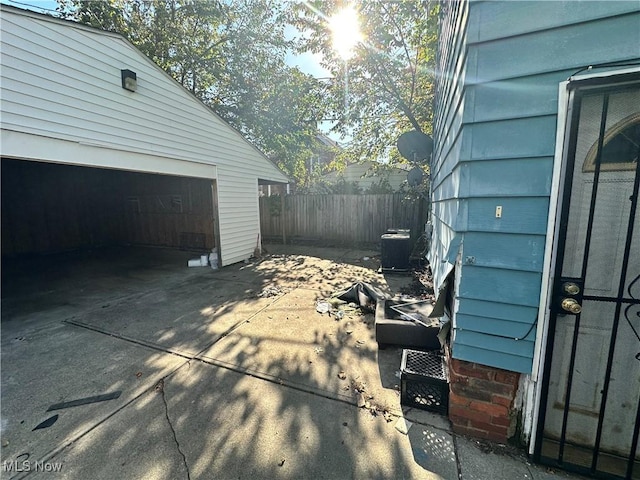 16512 Burnside Ave, Cleveland, OH 44110 - view of side of home with fence and a garage