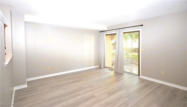 empty room with light hardwood / wood-style flooring