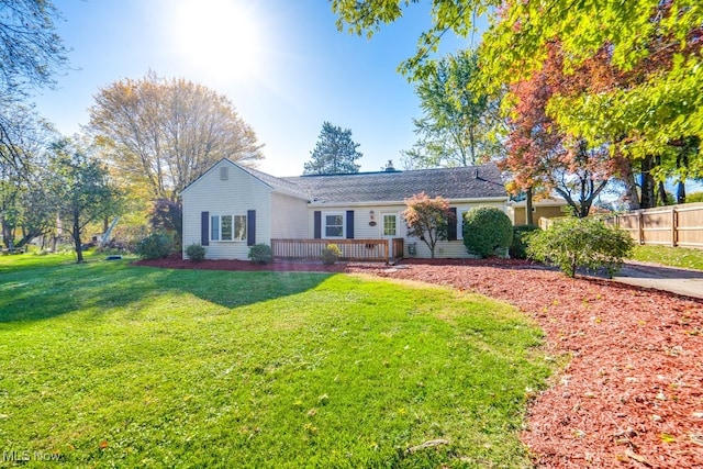 single story home featuring a front lawn and a deck