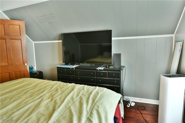 bedroom featuring dark hardwood / wood-style floors and wood walls