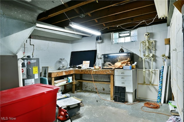 basement featuring water heater and a workshop area