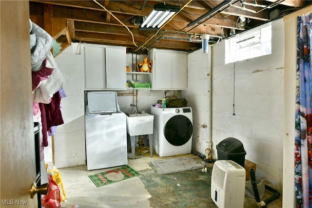 clothes washing area featuring sink and washing machine and dryer