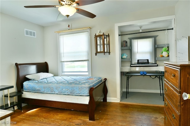 bedroom with ceiling fan and dark hardwood / wood-style flooring