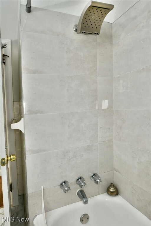 bathroom with tiled shower / bath combo