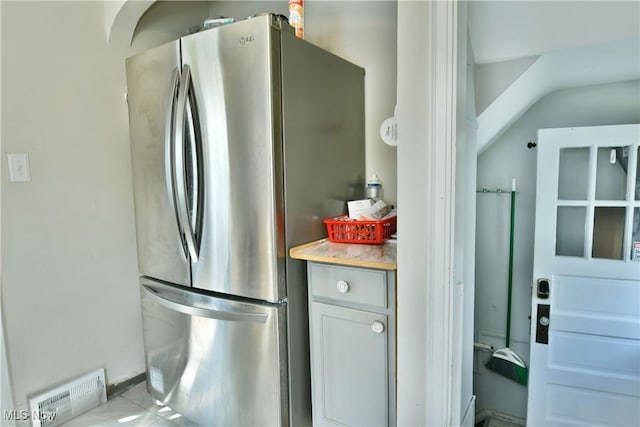 kitchen featuring stainless steel refrigerator and light tile patterned floors