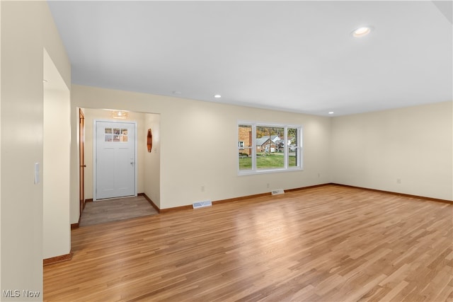 spare room with light hardwood / wood-style flooring