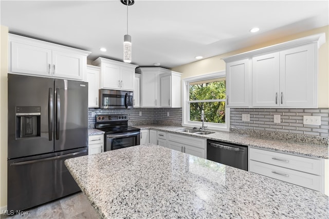 kitchen with tasteful backsplash, sink, white cabinetry, stainless steel appliances, and pendant lighting