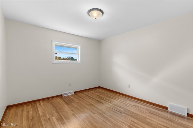 spare room featuring light hardwood / wood-style floors