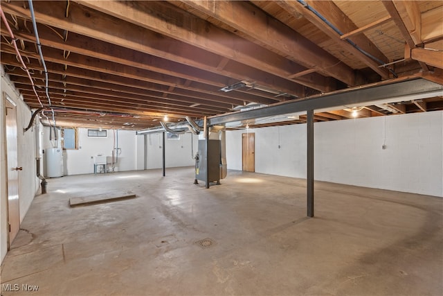 basement with water heater, sink, and heating unit