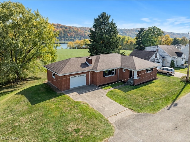 birds eye view of property with a water and mountain view