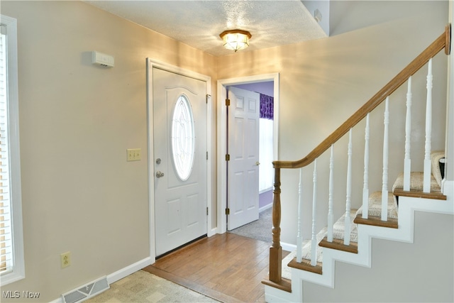 foyer with wood-type flooring