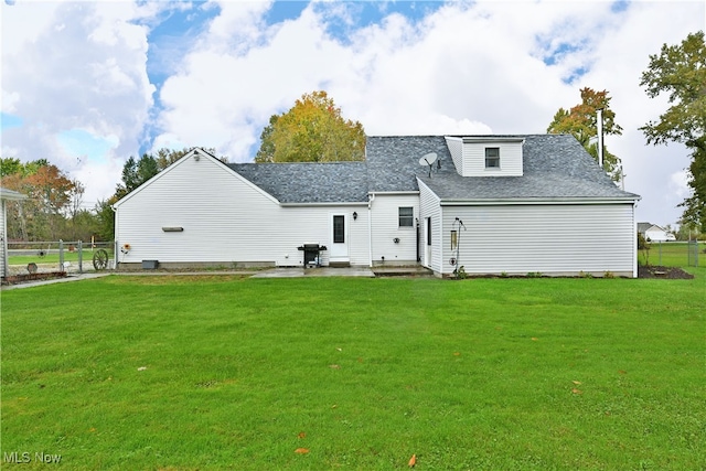 back of property featuring a yard and a patio