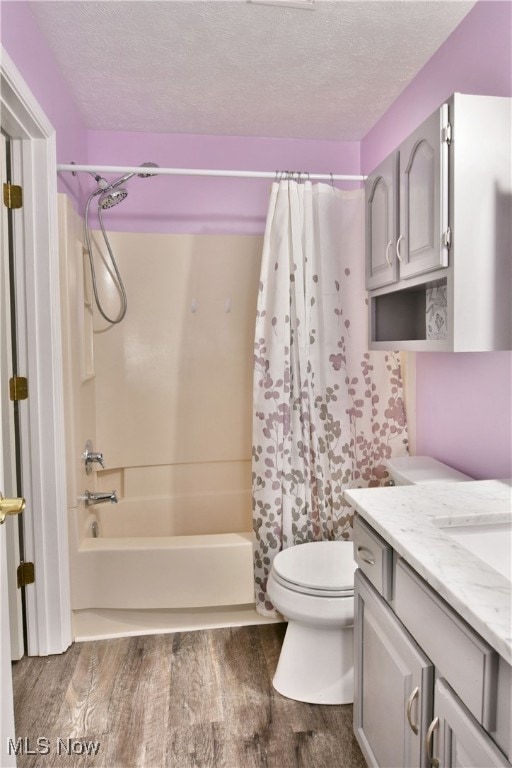 full bathroom with vanity, shower / tub combo with curtain, toilet, and wood-type flooring