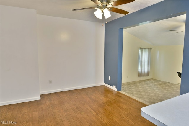 spare room featuring ceiling fan, hardwood / wood-style flooring, and lofted ceiling