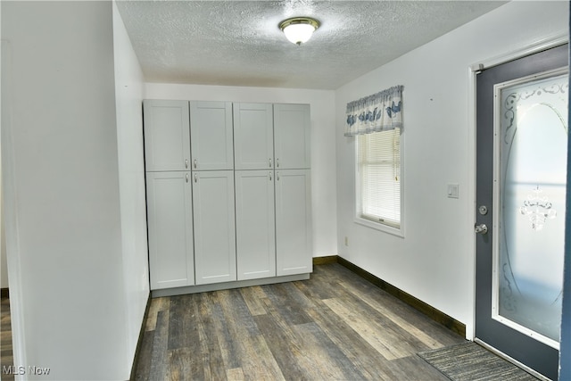 entryway featuring a textured ceiling and dark hardwood / wood-style floors