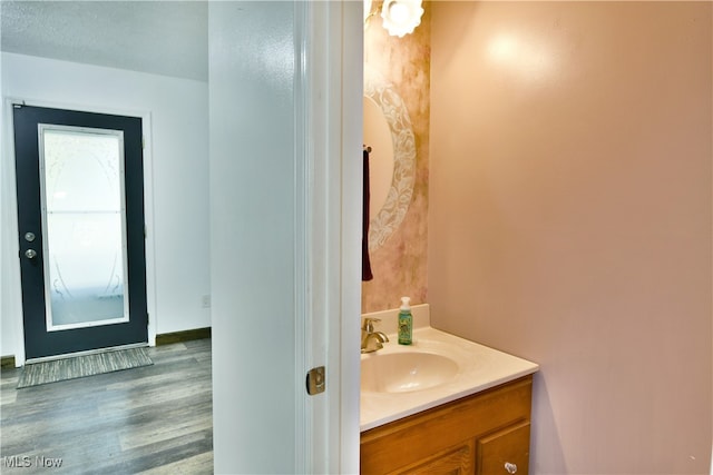 bathroom featuring vanity, hardwood / wood-style flooring, and a textured ceiling