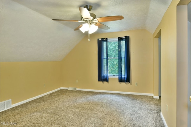 additional living space featuring ceiling fan, a textured ceiling, lofted ceiling, and carpet floors