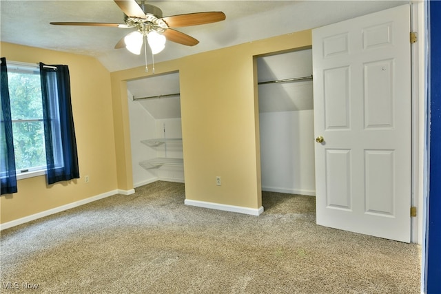 unfurnished bedroom featuring light carpet, vaulted ceiling, and ceiling fan