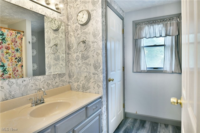 bathroom featuring vanity, a textured ceiling, and hardwood / wood-style floors