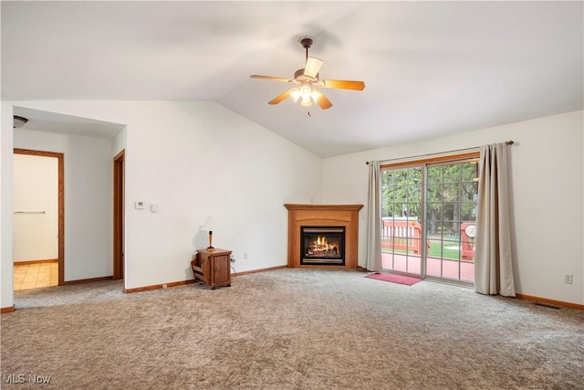 unfurnished living room with ceiling fan, carpet, and lofted ceiling