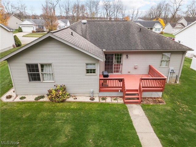 back of house with a yard and a wooden deck