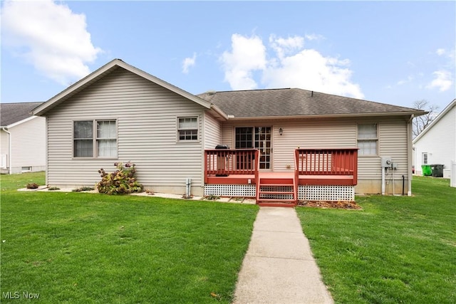 rear view of house featuring a deck and a lawn