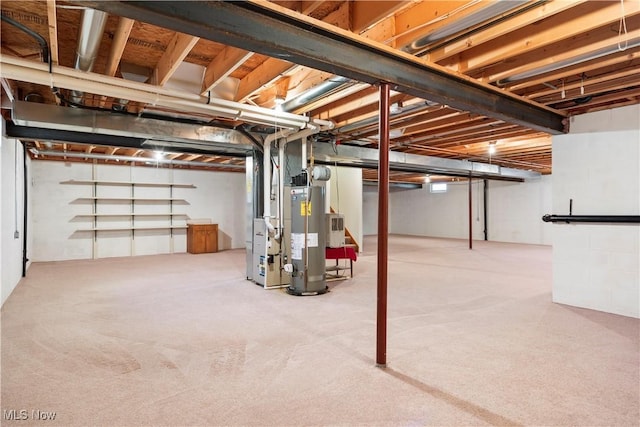 basement with gas water heater and carpet flooring