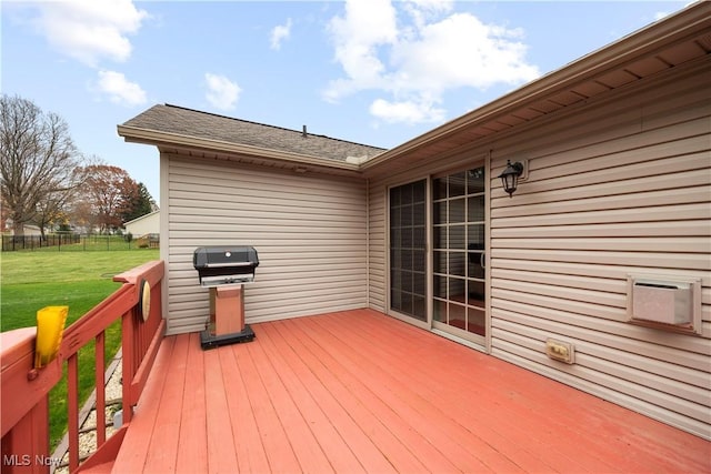 wooden deck with grilling area and a lawn