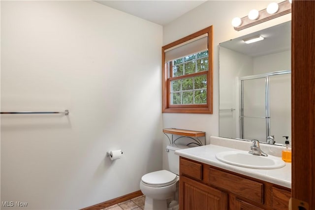 bathroom with a shower with shower door, tile patterned floors, toilet, and vanity