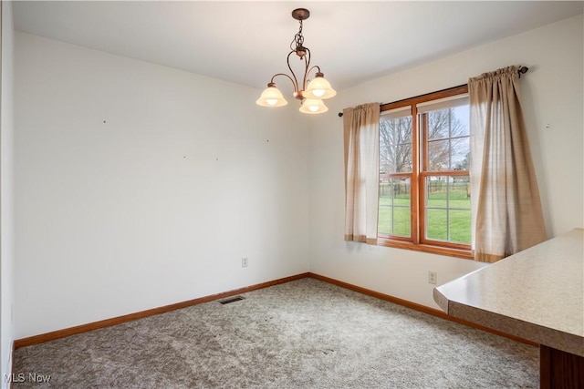 unfurnished dining area featuring carpet flooring and a notable chandelier