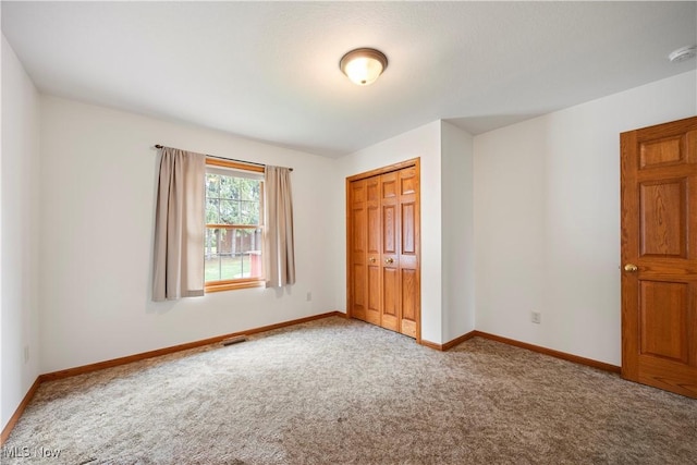 unfurnished bedroom with carpet floors and a closet