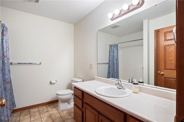 bathroom with toilet and vanity