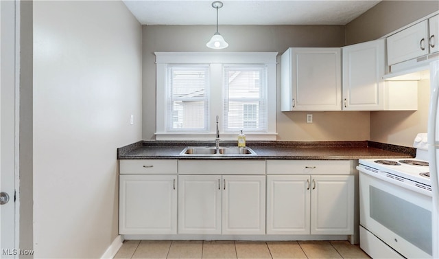 kitchen featuring white electric range, hanging light fixtures, sink, light tile patterned floors, and white cabinetry